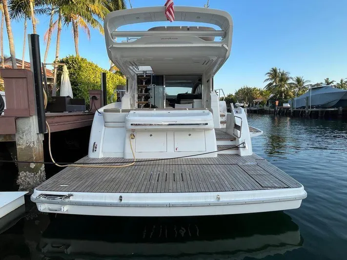 510 Schaefer Yacht Photos Pics 2019 Schaefer 510 yacht docked, rear view with open deck and calm water.