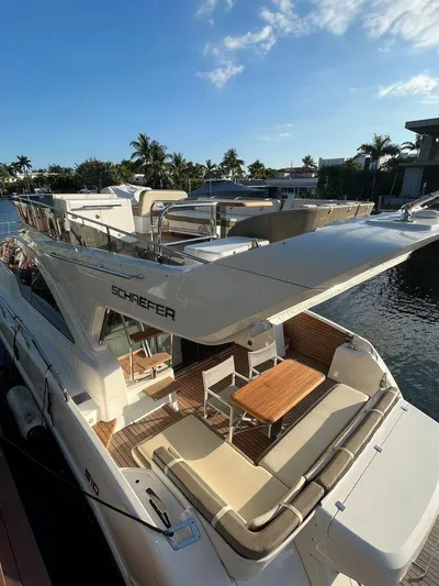 510 Schaefer Yacht Photos Pics Luxurious 2019 Schaefer 510 yacht docked, featuring elegant outdoor seating and sleek design.