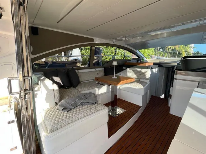 510 Schaefer Yacht Photos Pics Luxurious interior of a 2019 Schaefer 510 yacht with elegant seating and wooden flooring.