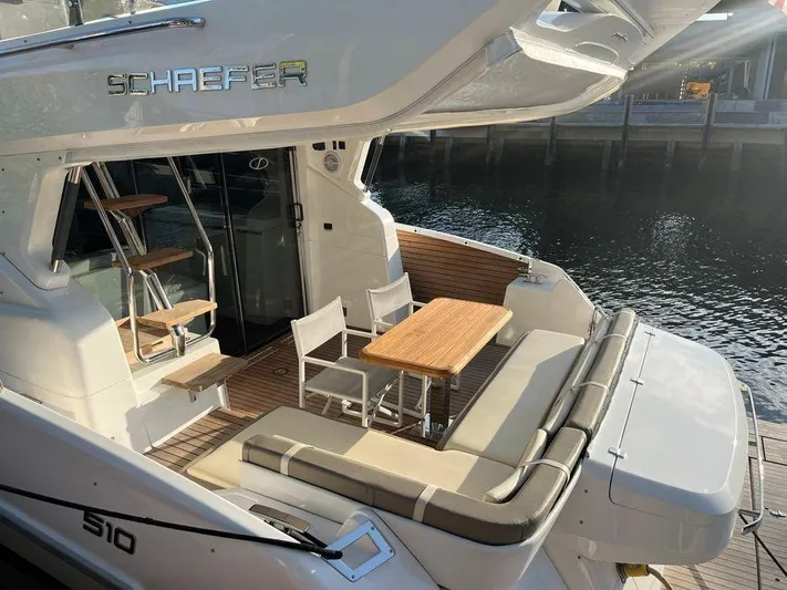 510 Schaefer Yacht Photos Pics Luxurious 2019 Schaefer 510 yacht with elegant outdoor seating and dining area by the water.