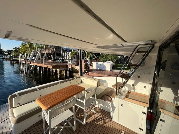 510 Schaefer Yacht Photos Pics Luxurious 2019 Schaefer 510 yacht deck with seating and table, docked by waterfront.