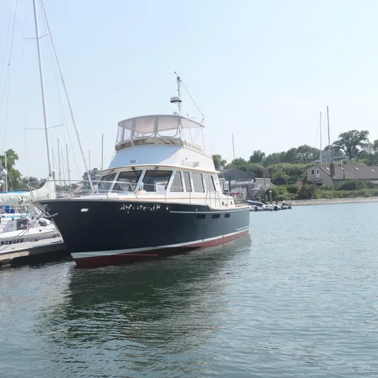 Whirlaway Yacht Photos Pics Alden Motor Yacht 2020 docked in a serene marina setting.