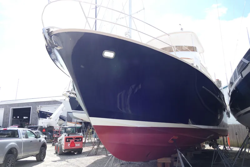 Whirlaway Yacht Photos Pics 2020 Alden Motor Yacht in dry dock, blue hull, red bottom, marina setting.