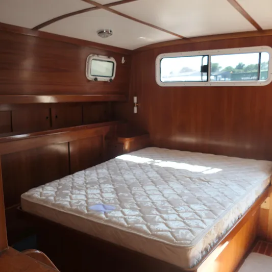 Whirlaway Yacht Photos Pics Alden Motor Yacht 2020 interior cabin with wooden finish and bed.