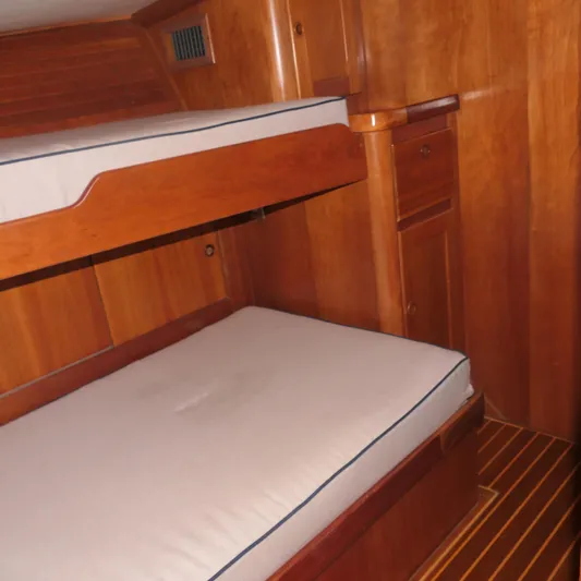 Whirlaway Yacht Photos Pics Interior of 2020 Alden Motor Yacht with wooden bunk beds and cabinetry.