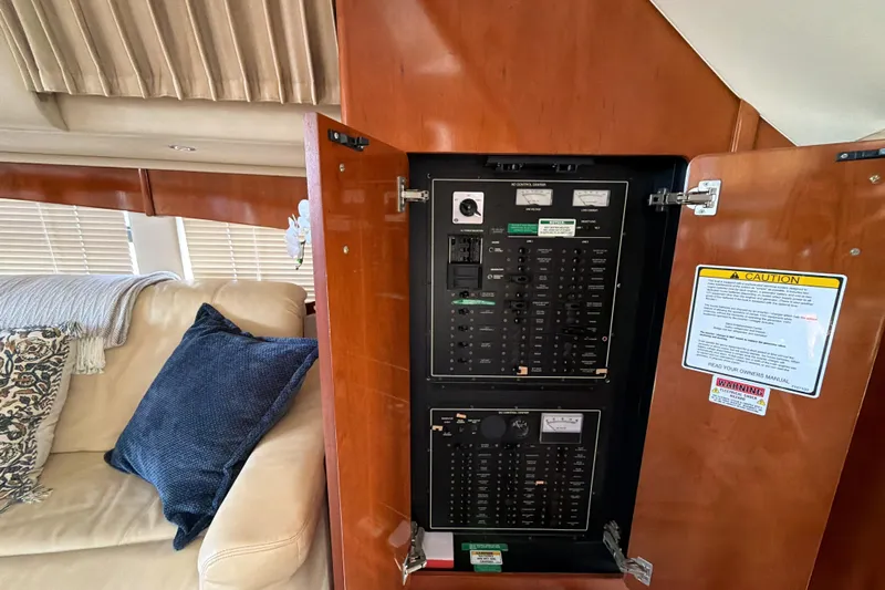  Yacht Photos Pics Electrical panel inside 2003 Carver 564 Cockpit Motor Yacht, with cozy seating area.