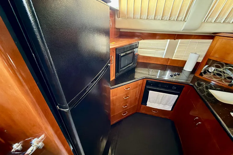  Yacht Photos Pics Luxurious kitchen interior of 2003 Carver 564 Cockpit Motor Yacht with modern appliances.