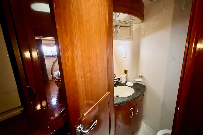  Yacht Photos Pics 2003 Carver 564 Cockpit Motor Yacht bathroom with wooden cabinetry and sink.
