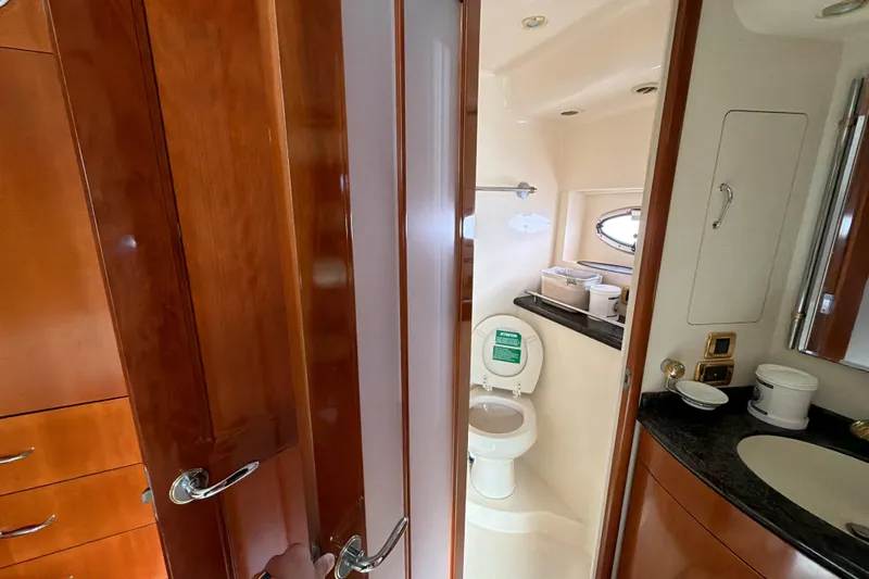 Yacht Photos Pics Interior of 2003 Carver 564 Cockpit Motor Yacht bathroom with wooden cabinetry.
