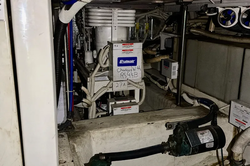  Yacht Photos Pics Engine room of 2003 Carver 564 Cockpit Motor Yacht with mechanical equipment and wiring.