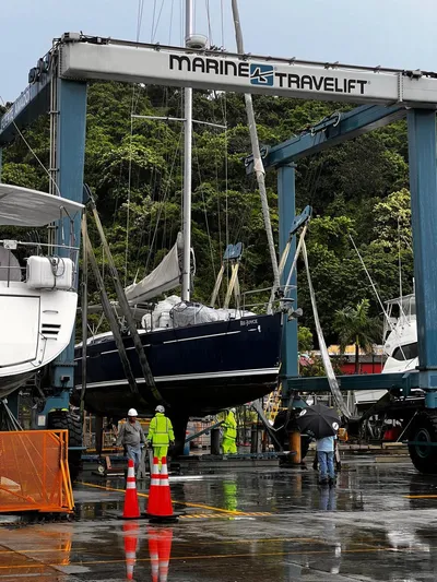 Rejoyce Yacht Photos Pics 2010 Beneteau Oceanis 54 sailboat lifted by Marine Travelift at a marina.