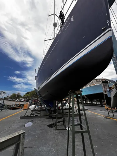 Rejoyce Yacht Photos Pics 2010 Beneteau Oceanis 54 sailboat on dry dock under a partly cloudy sky.