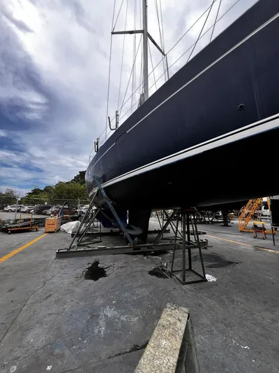 Rejoyce Yacht Photos Pics 2010 Beneteau Oceanis 54 sailboat on dry dock, under a cloudy sky.
