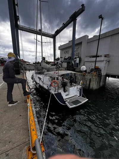 Rejoyce Yacht Photos Pics Beneteau Oceanis 54 sailboat docked at marina, cloudy sky, 2010 model.