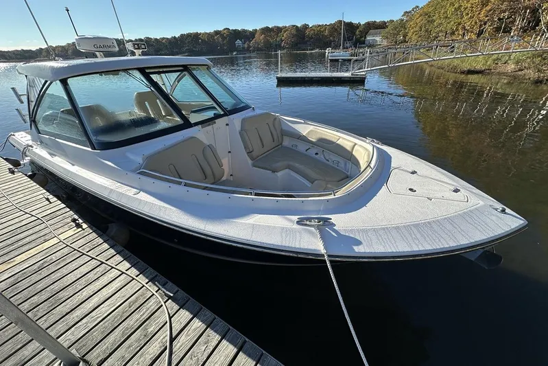Soul Mates Yacht Photos Pics 2016 Pursuit DC 325 Dual Console boat docked on a calm lake.