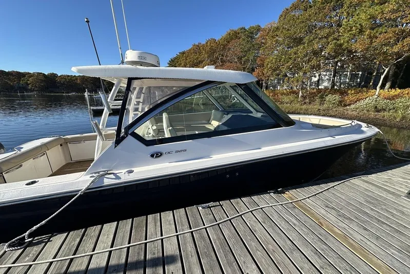 Soul Mates Yacht Photos Pics 2016 Pursuit DC 325 Dual Console boat docked by a serene lake.