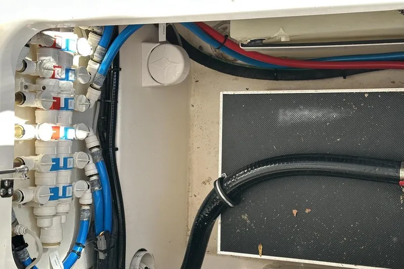 Soul Mates Yacht Photos Pics 2016 Pursuit DC 325 Dual Console boat plumbing system with blue and red hoses.