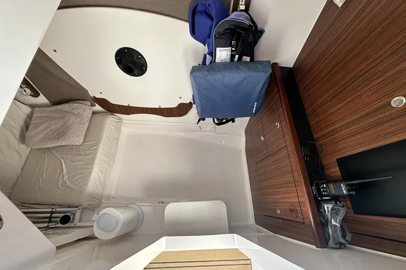 Soul Mates Yacht Photos Pics 2016 Pursuit DC 325 Dual Console cabin interior with wood cabinetry and seating area.