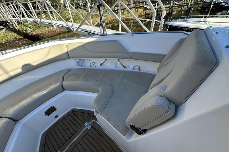 Soul Mates Yacht Photos Pics 2016 Pursuit DC 325 Dual Console boat interior with cushioned seating and wooden flooring.
