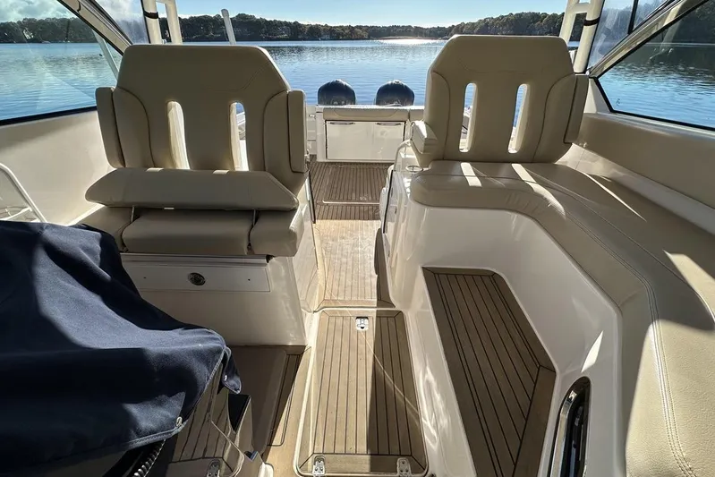 Soul Mates Yacht Photos Pics 2016 Pursuit DC 325 Dual Console interior with seating, overlooking a serene lake view.