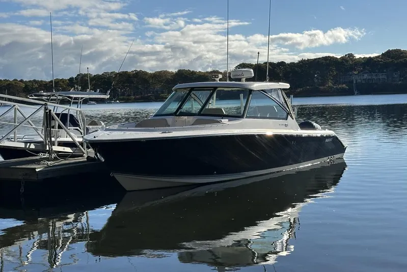 Soul Mates Yacht Photos Pics 2016 Pursuit DC 325 Dual Console boat docked on calm water under a blue sky.