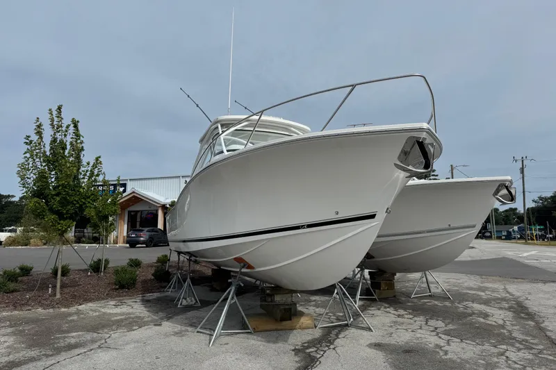  Yacht Photos Pics 2024 Albemarle 30 Express boats on stands in a parking lot.