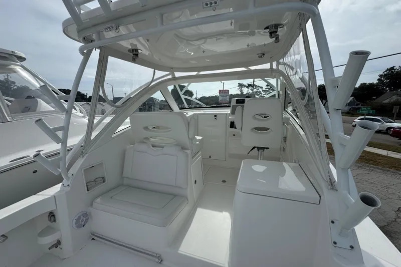  Yacht Photos Pics 2024 Albemarle 30 Express boat interior with white seating and helm station.