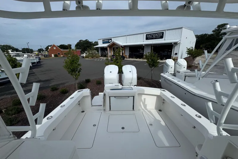  Yacht Photos Pics 2024 Albemarle 30 Express boat at marina with twin engines and outdoor store in background.