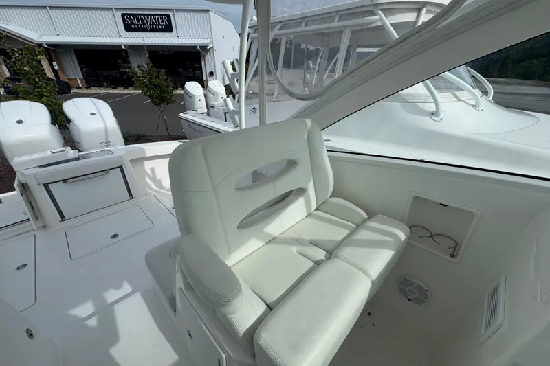  Yacht Photos Pics 2024 Albemarle 30 Express boat interior with white seating and outdoor view.