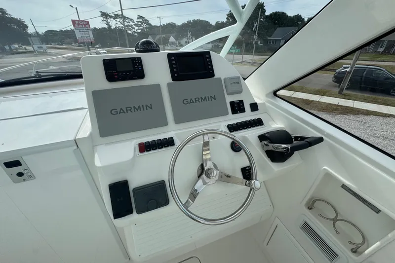  Yacht Photos Pics 2024 Albemarle 30 Express helm with Garmin navigation, steering wheel, and control panel.