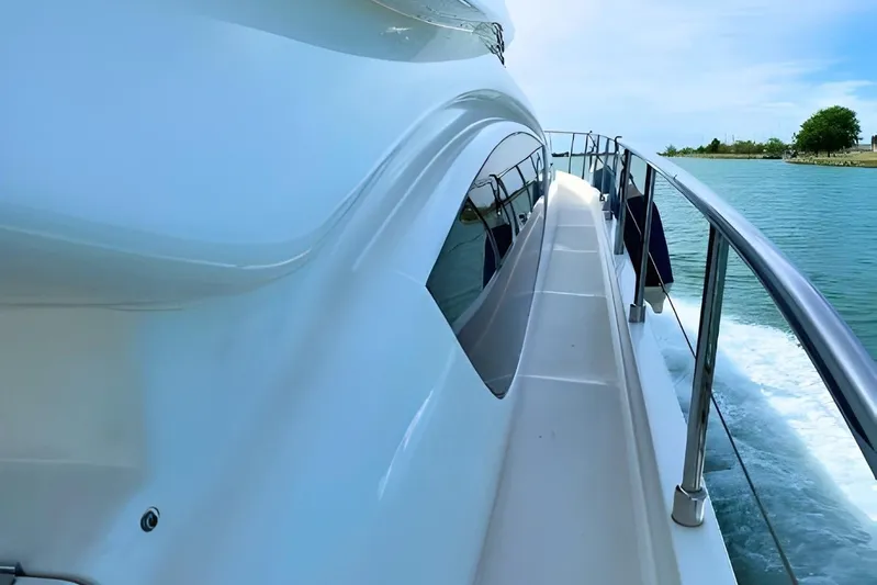  Yacht Photos Pics Side view of 2005 Ferretti Yachts 550 cruising on a serene waterway.