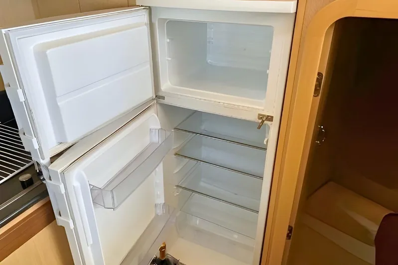  Yacht Photos Pics Empty refrigerator inside 2005 Ferretti Yachts 550, showcasing interior storage space.