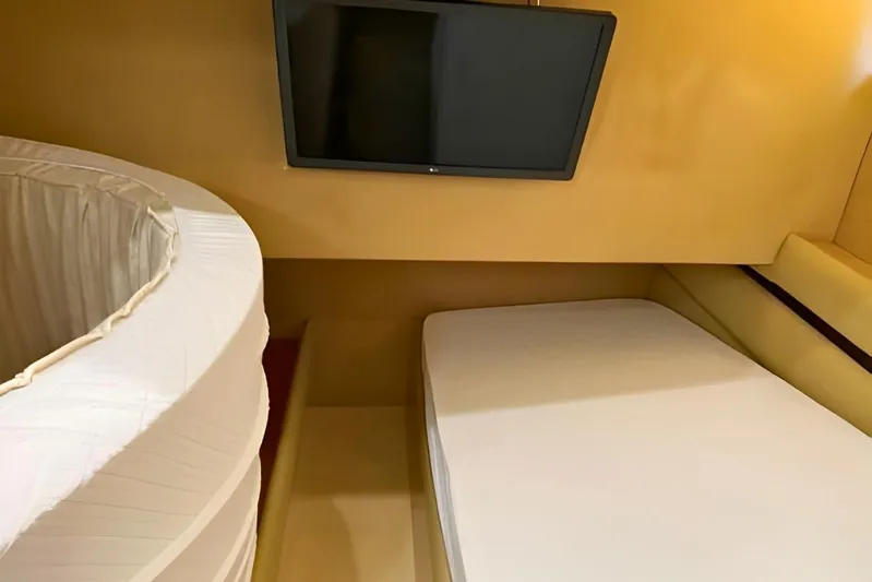  Yacht Photos Pics Interior cabin of 2005 Ferretti Yachts 550 with bed and wall-mounted TV.