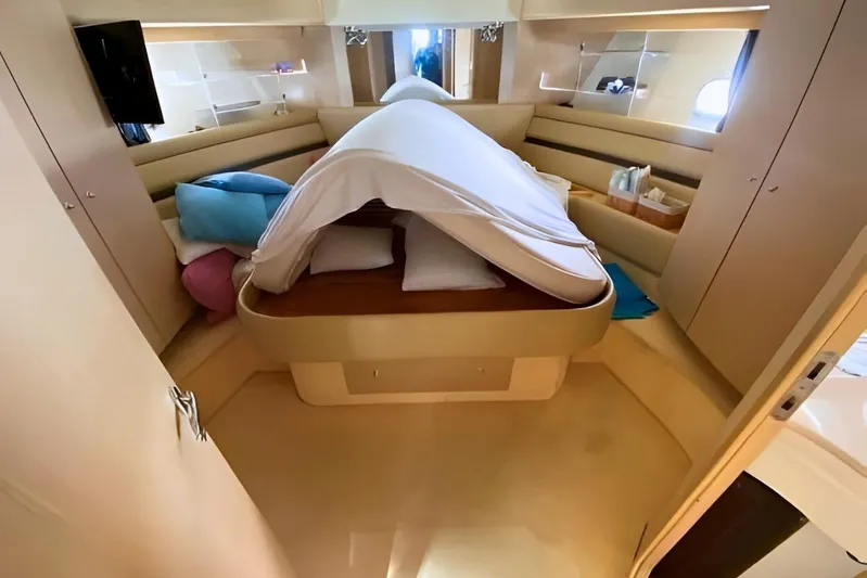  Yacht Photos Pics Luxurious cabin interior of 2005 Ferretti Yachts 550 with cozy bedding and modern design.