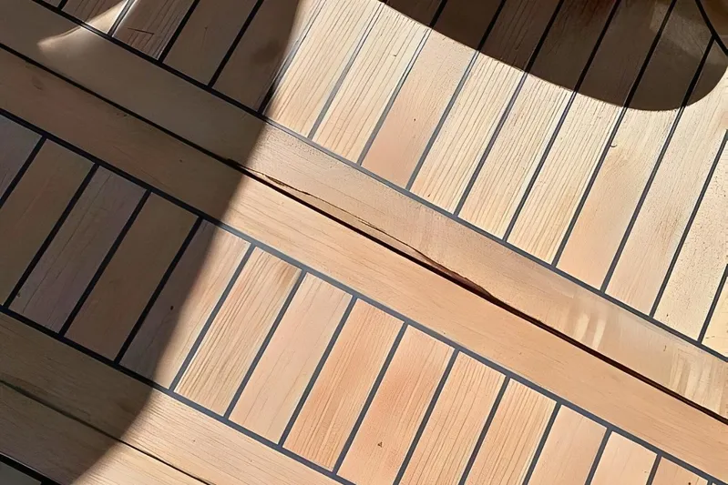  Yacht Photos Pics Teak deck of 2005 Ferretti Yachts 550, showcasing elegant wood grain and shadow play.