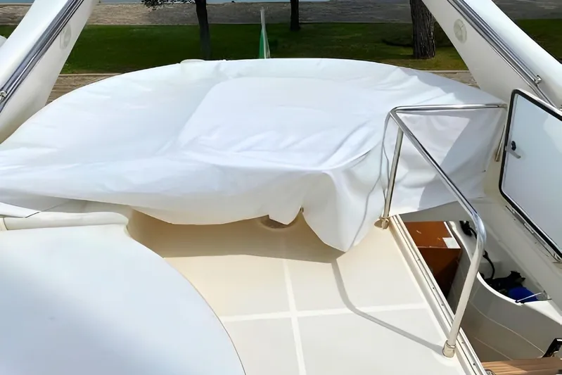  Yacht Photos Pics 2005 Ferretti Yachts 550 deck with white cover and stainless steel railing.