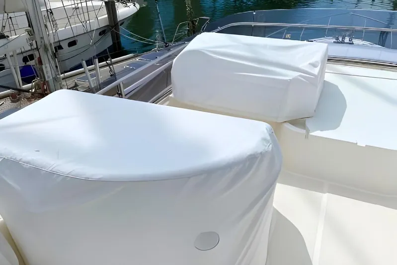 Yacht Photos Pics Covered deck area on a 2005 Ferretti Yachts 550, docked by the water.