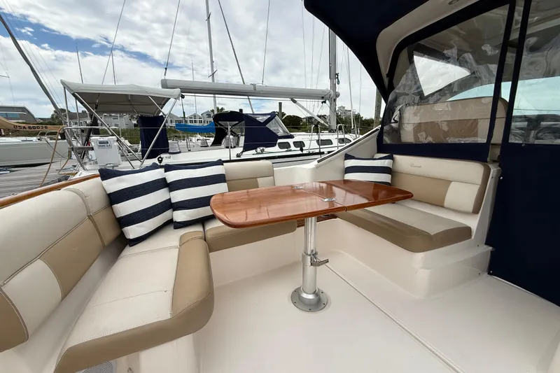  Yacht Photos Pics Luxurious 2012 Tiara Yachts 3100 Coronet interior with elegant seating and wooden table.