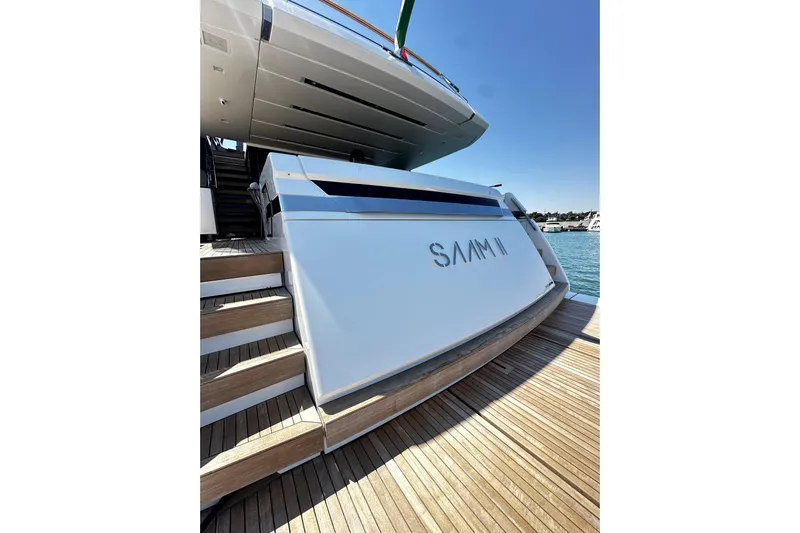 Saam II Yacht Photos Pics 2024 Sanlorenzo SL96 yacht stern view with wooden steps and water backdrop.