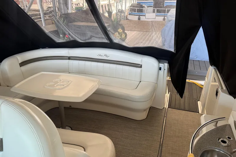  Yacht Photos Pics 2007 Sea Ray Sundancer 400 interior with white seating and table, docked at marina.