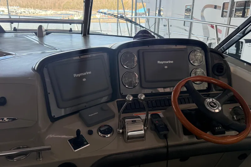  Yacht Photos Pics 2007 Sea Ray Sundancer 400 helm with Raymarine navigation system and wooden steering wheel.