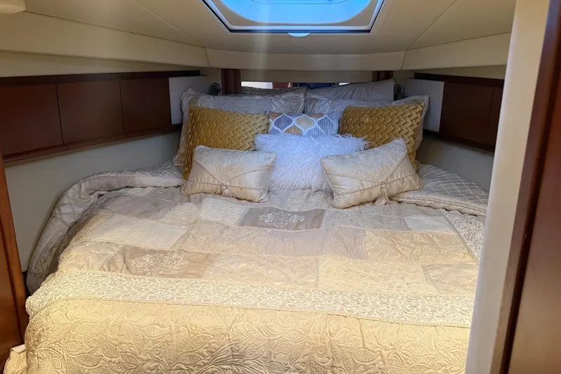  Yacht Photos Pics Luxurious cabin interior of 2007 Sea Ray Sundancer 400 with plush bedding and skylight.