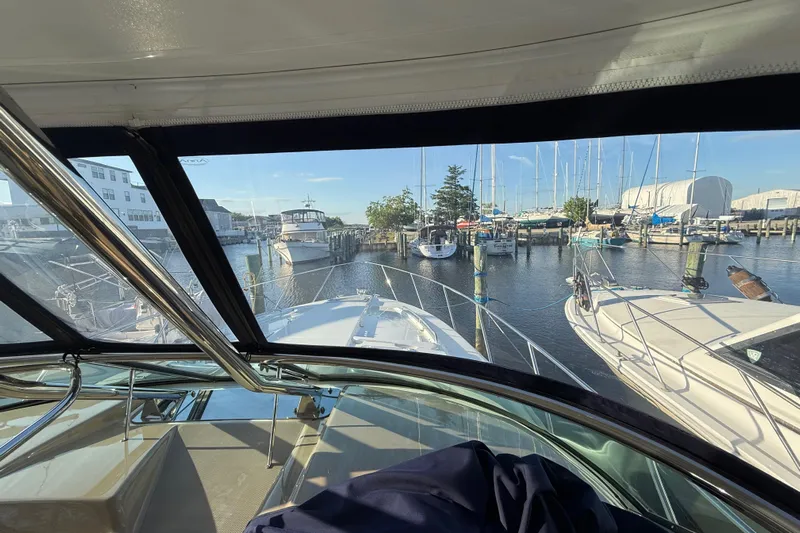  Yacht Photos Pics 2016 Formula 37 Performance Cruiser docked at marina, surrounded by sailboats and clear blue sky.
