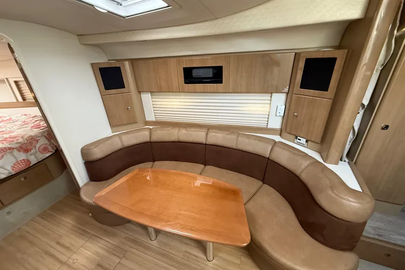  Yacht Photos Pics 2016 Formula 37 Performance Cruiser interior with curved seating and wooden table.