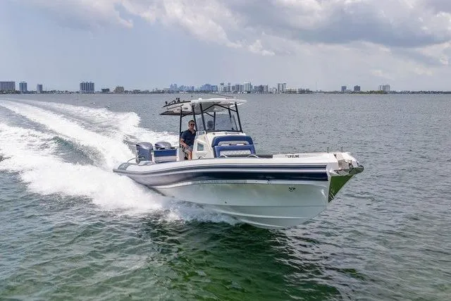  Yacht Photos Pics 2018 RIB CVL Colt 35 boat cruising on open water with city skyline in background.