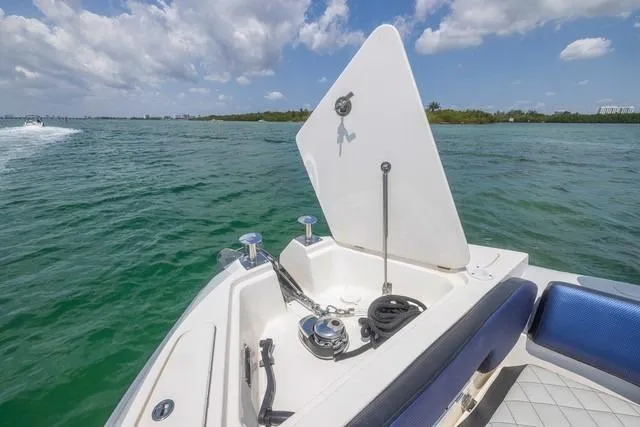  Yacht Photos Pics RIB CVL Colt 35 boat, 2018 model, open storage compartment, on calm water under blue sky.