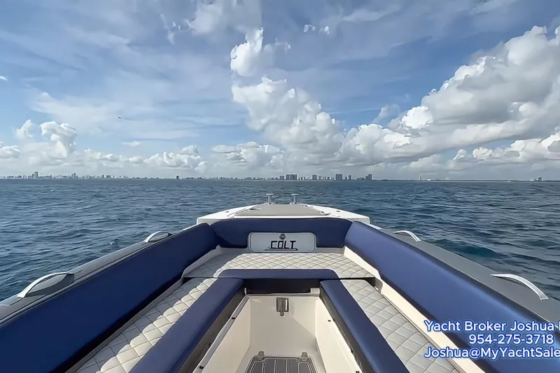  Yacht Photos Pics RIB CVL Colt 35 boat on open sea, 2018 model, with city skyline in background.