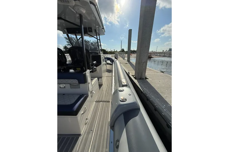  Yacht Photos Pics 2018 RIB CVL Colt 35 boat docked, showcasing sleek design and seating area.