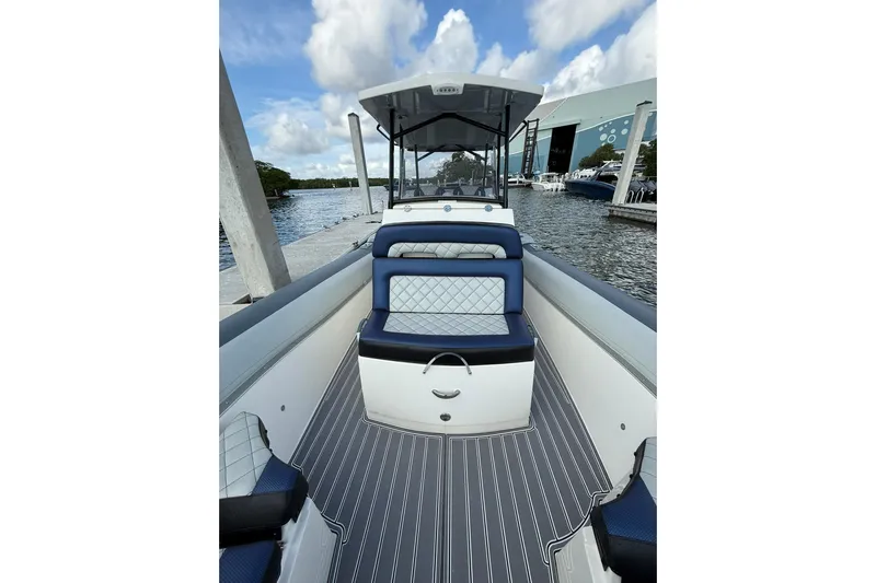  Yacht Photos Pics 2018 RIB CVL Colt 35 boat interior with blue seating, docked by the water.