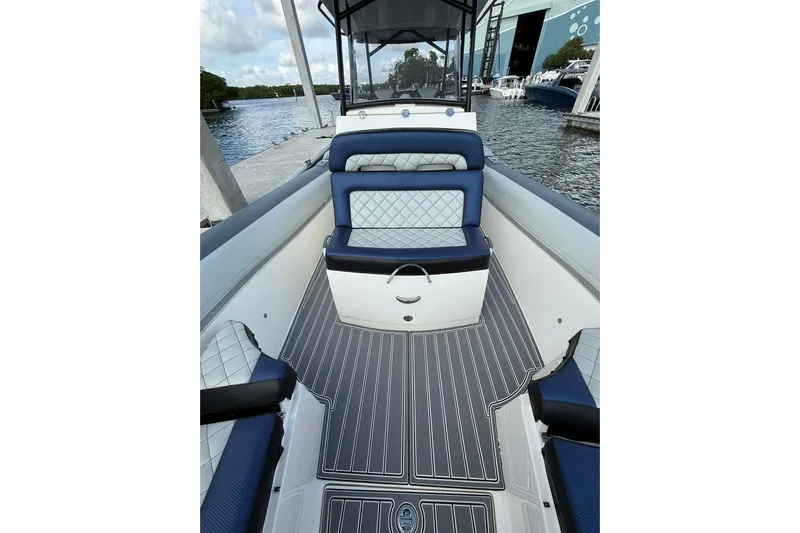  Yacht Photos Pics 2018 RIB CVL Colt 35 boat interior with blue and white seating, docked by the water.